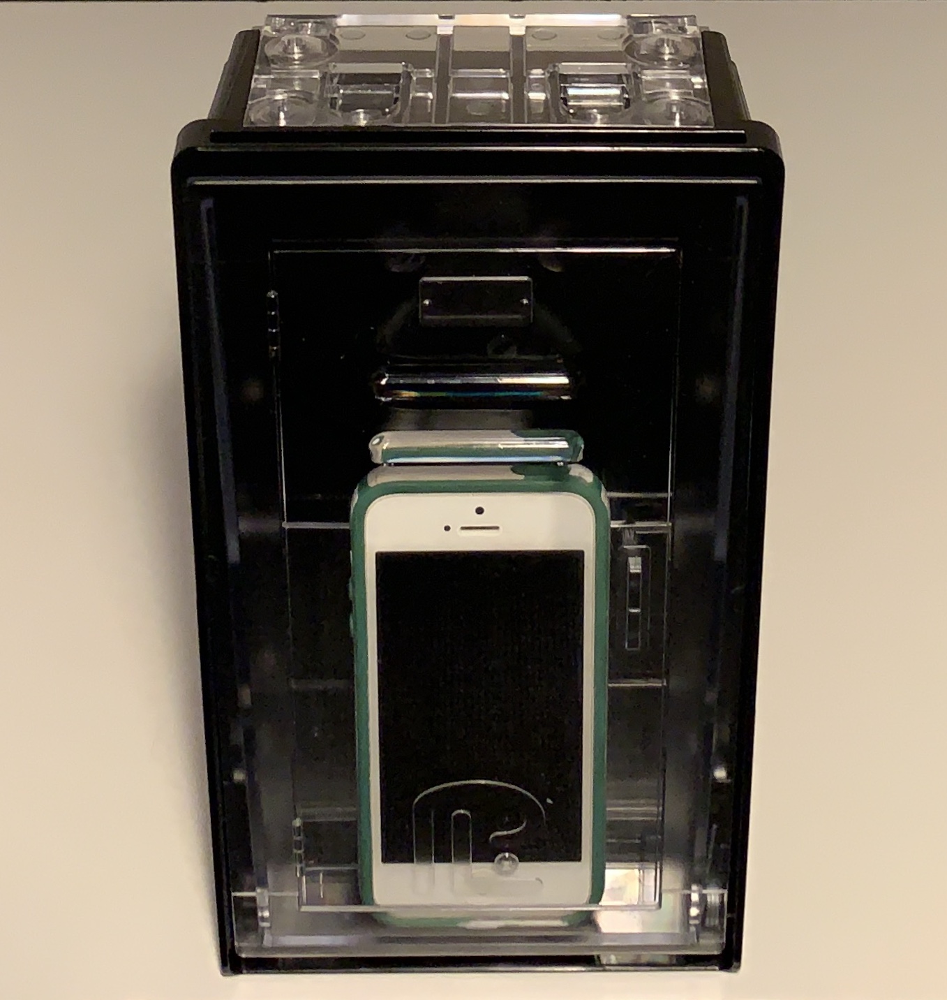 A cell phone is in the case and there are two other cellphones.