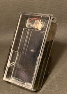 A small plastic box with a wire attached to it.