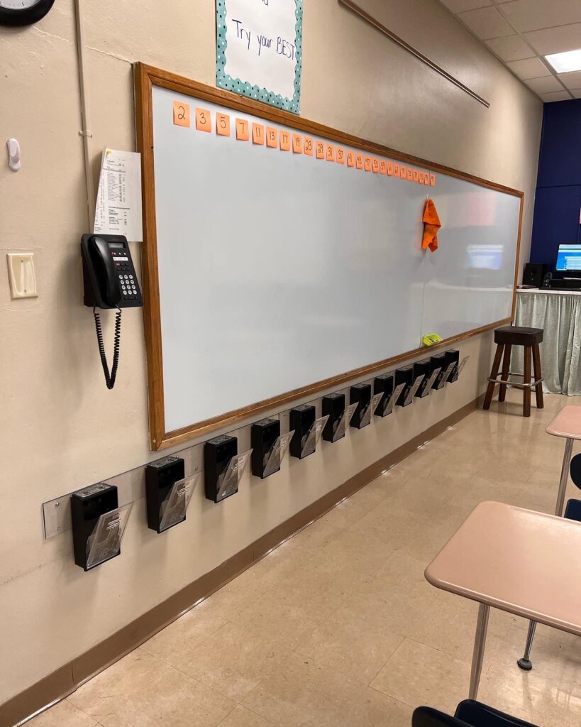 A classroom with a whiteboard and telephone